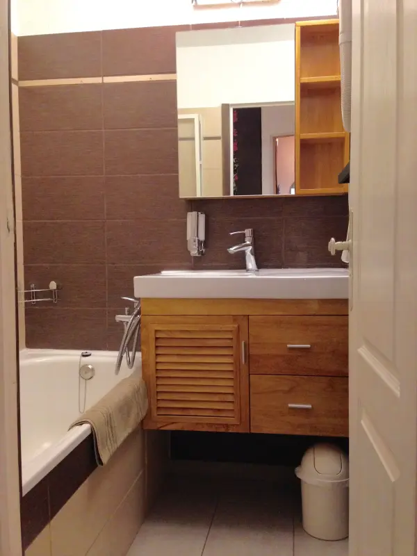 Salle de bain avec baignoire ou douche, sèche cheveux mural 